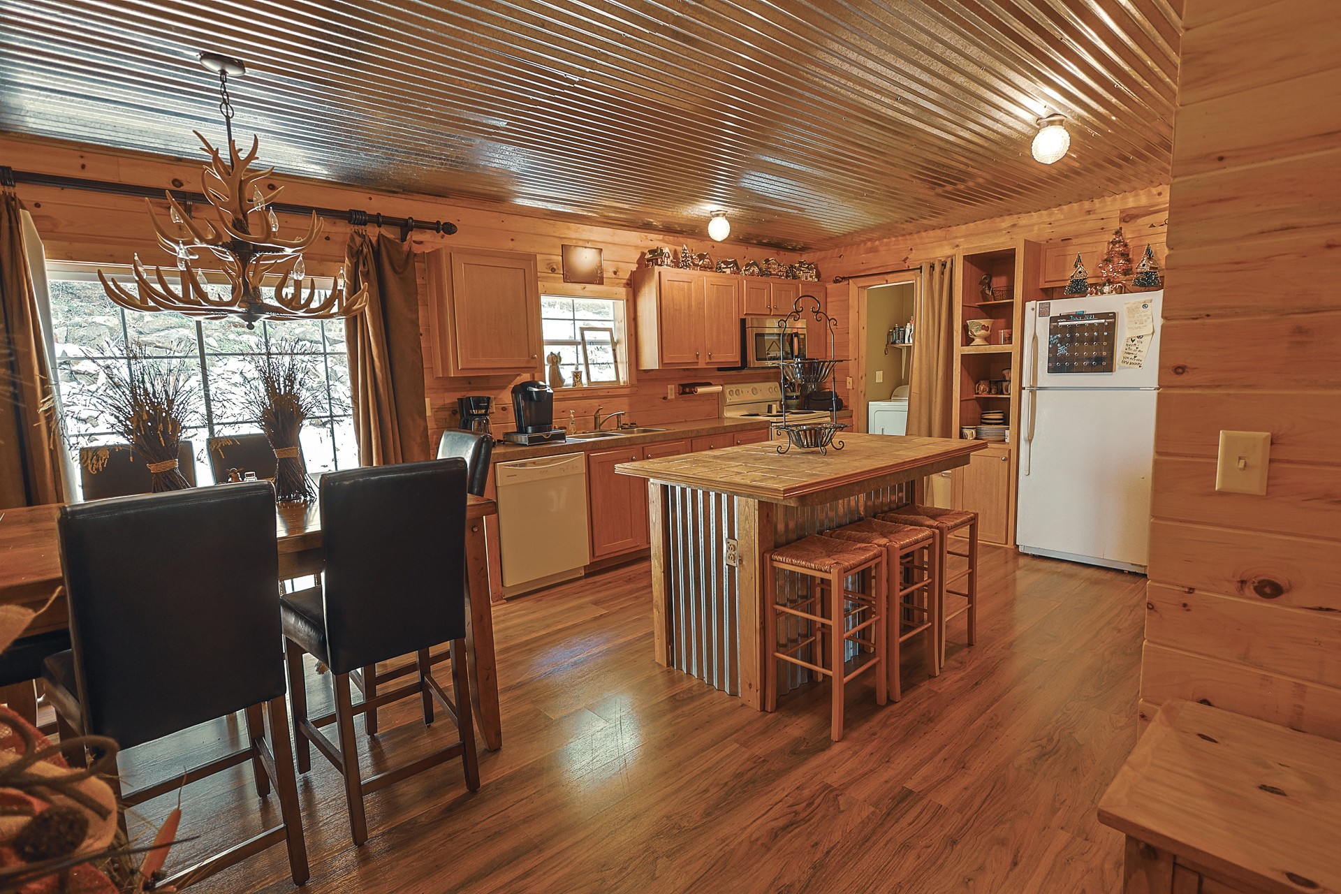 555 Lay Hollow Road Waynesboro, TN 38485 - Photo 19 of 68 a dining hall with stainless steel appliances granite countertop furniture wooden floor and a kitchen view
