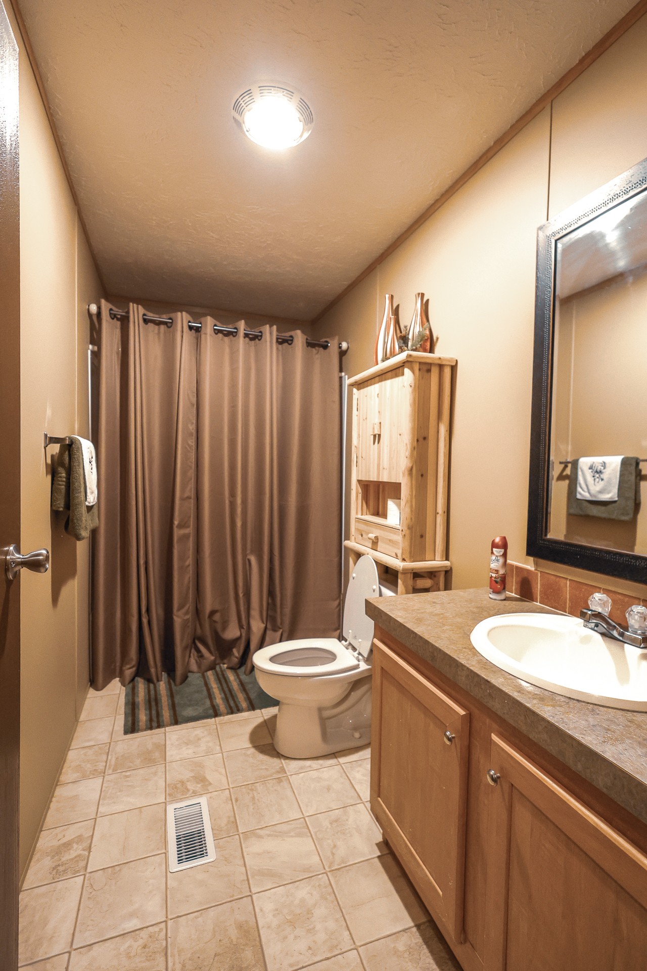 555 Lay Hollow Road Waynesboro, TN 38485 - Photo 28 of 68 a bathroom with a toilet a sink and mirror