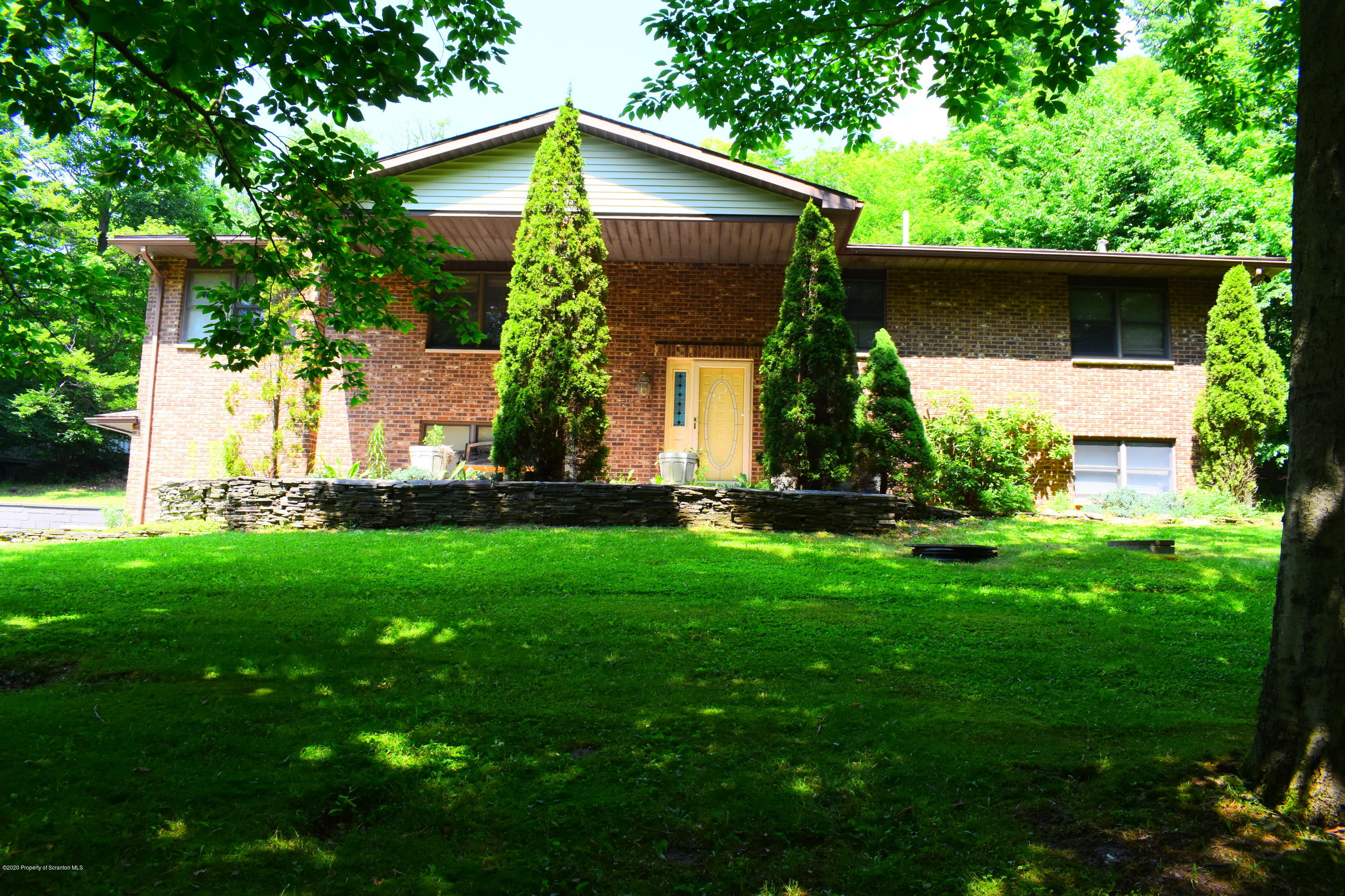 a front view of house with a garden