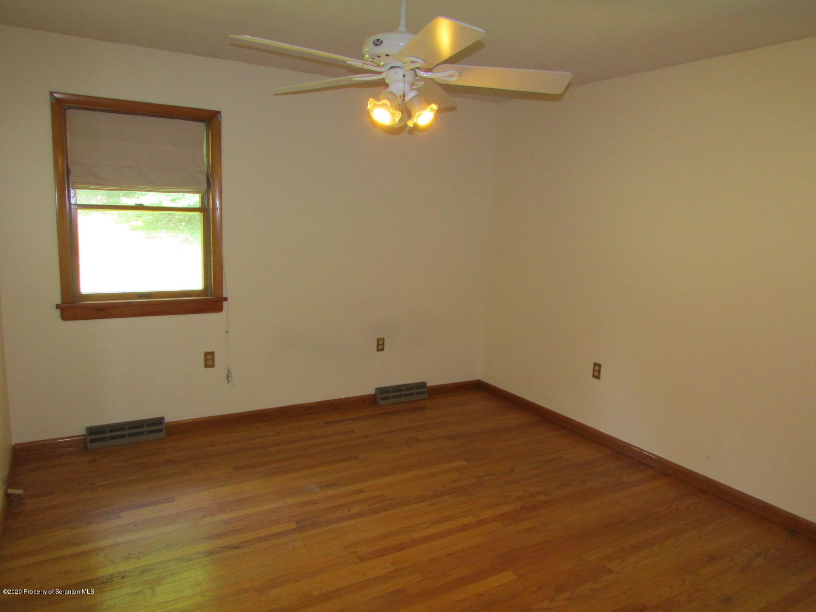 3322 North Road Montrose, PA 18801 - Photo 21 of 38 an empty room with a window and a fan