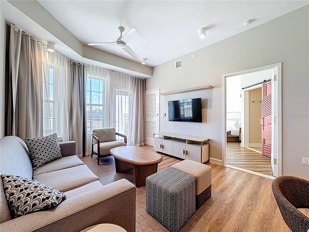 3151 Sunset Walk Drive, Unit 204 Kissimmee, FL 34747 - Photo 18 of 58 a living room with furniture and a flat screen tv