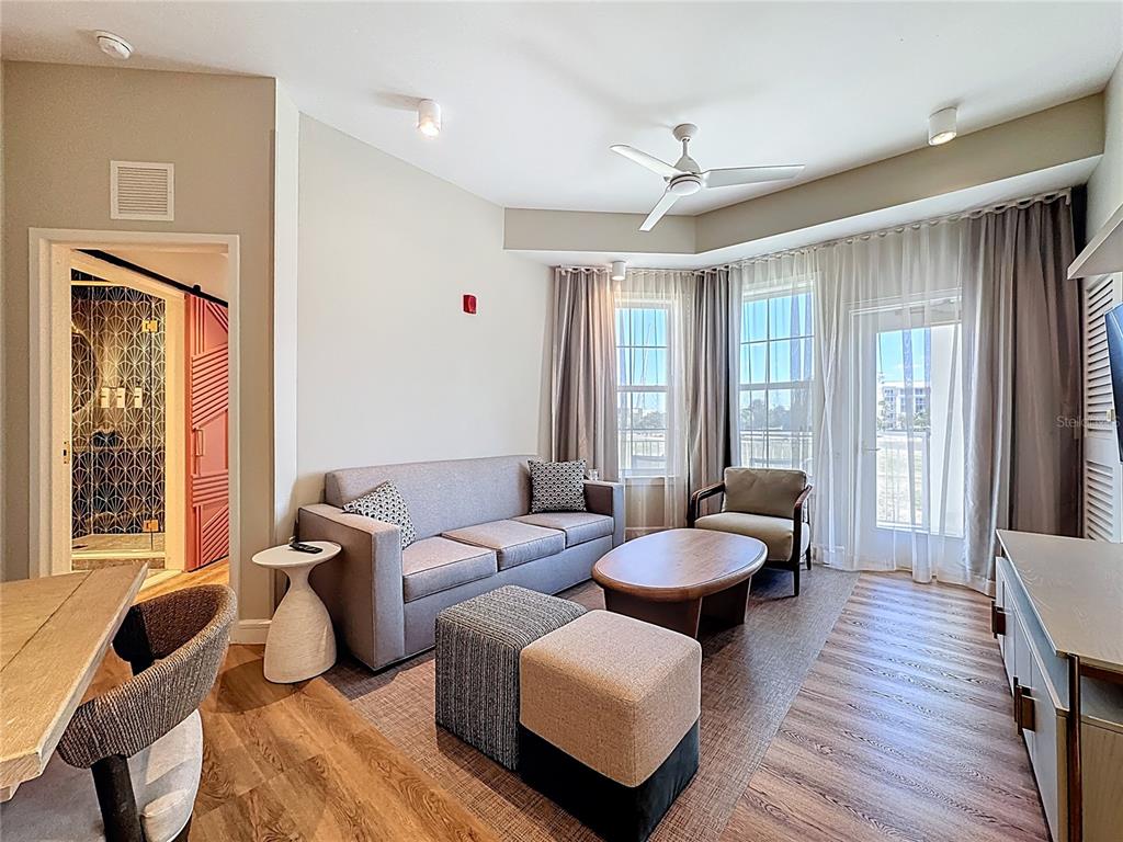 3151 Sunset Walk Drive, Unit 204 Kissimmee, FL 34747 - Photo 19 of 58 a living room with furniture and a large window