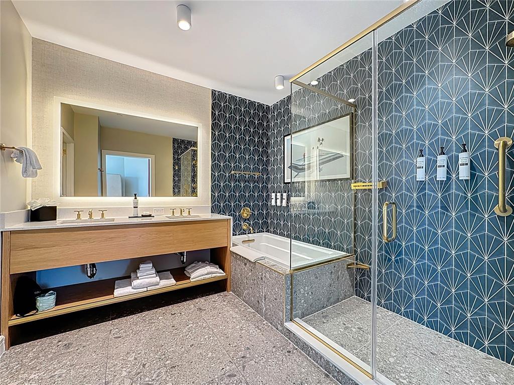 3151 Sunset Walk Drive, Unit 204 Kissimmee, FL 34747 - Photo 25 of 58 a bathroom with a tub sink and mirror