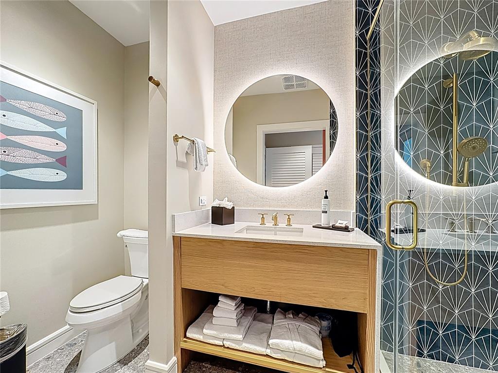 3151 Sunset Walk Drive, Unit 204 Kissimmee, FL 34747 - Photo 29 of 58 a bathroom with a toilet a sink and mirror