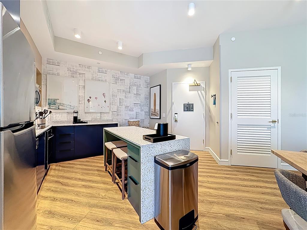 3151 Sunset Walk Drive, Unit 204 Kissimmee, FL 34747 - Photo 8 of 58 a kitchen with stainless steel appliances granite countertop a stove a sink dishwasher and a refrigerator