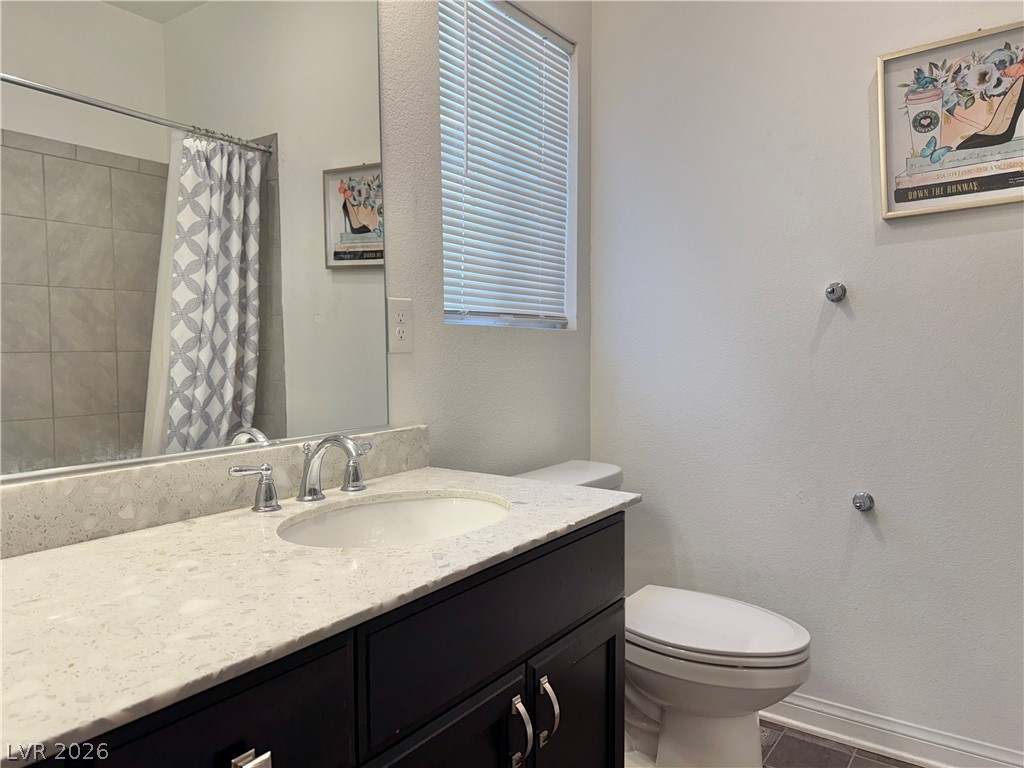 7777 South Westwind Road Las Vegas, NV 89139 - Photo 14 of 46 A well-appointed bath features a sleek vanity and tiled shower.