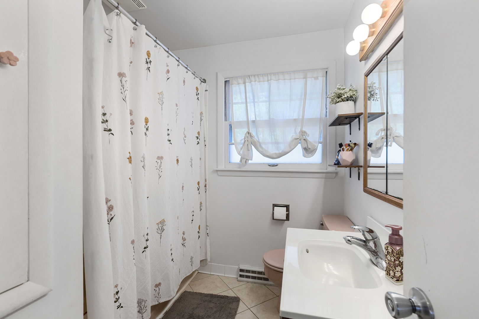 324 Alma Terrace Cary, IL 60013 - Photo 18 of 31 a bathroom with a sink a toilet and shower curtain