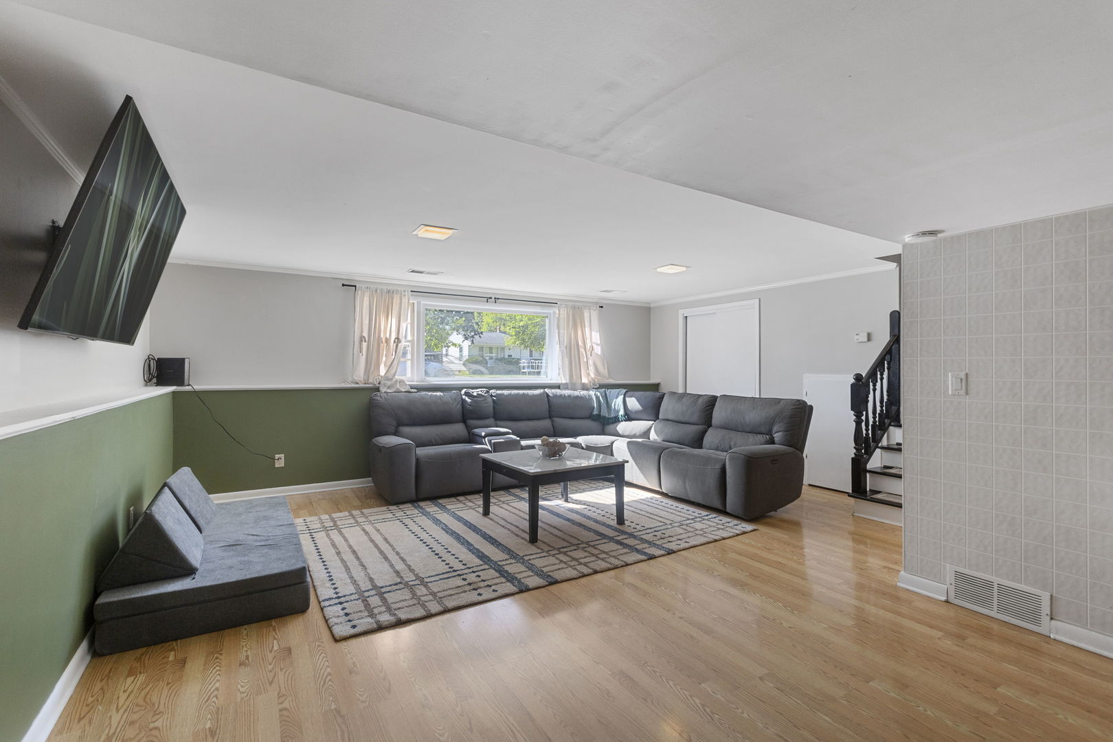 324 Alma Terrace Cary, IL 60013 - Photo 19 of 31 a living room with furniture and a flat screen tv