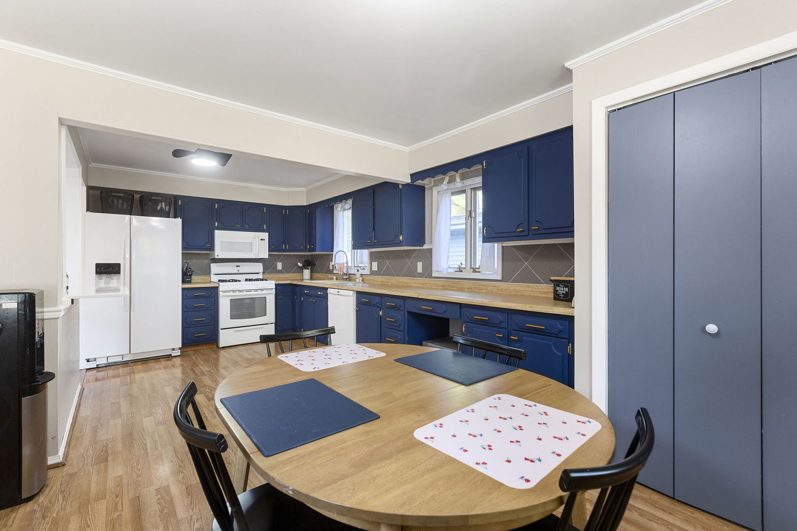 324 Alma Terrace Cary, IL 60013 - Photo 7 of 31 a kitchen with stainless steel appliances kitchen island granite countertop wooden cabinets a dining table and chairs