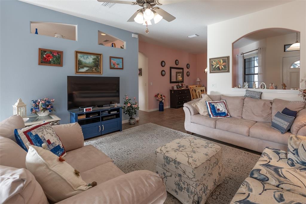 15969 Southwest 14th Avenue Road Ocala, FL 34473 - Photo 5 of 46 a living room with furniture and a flat screen tv