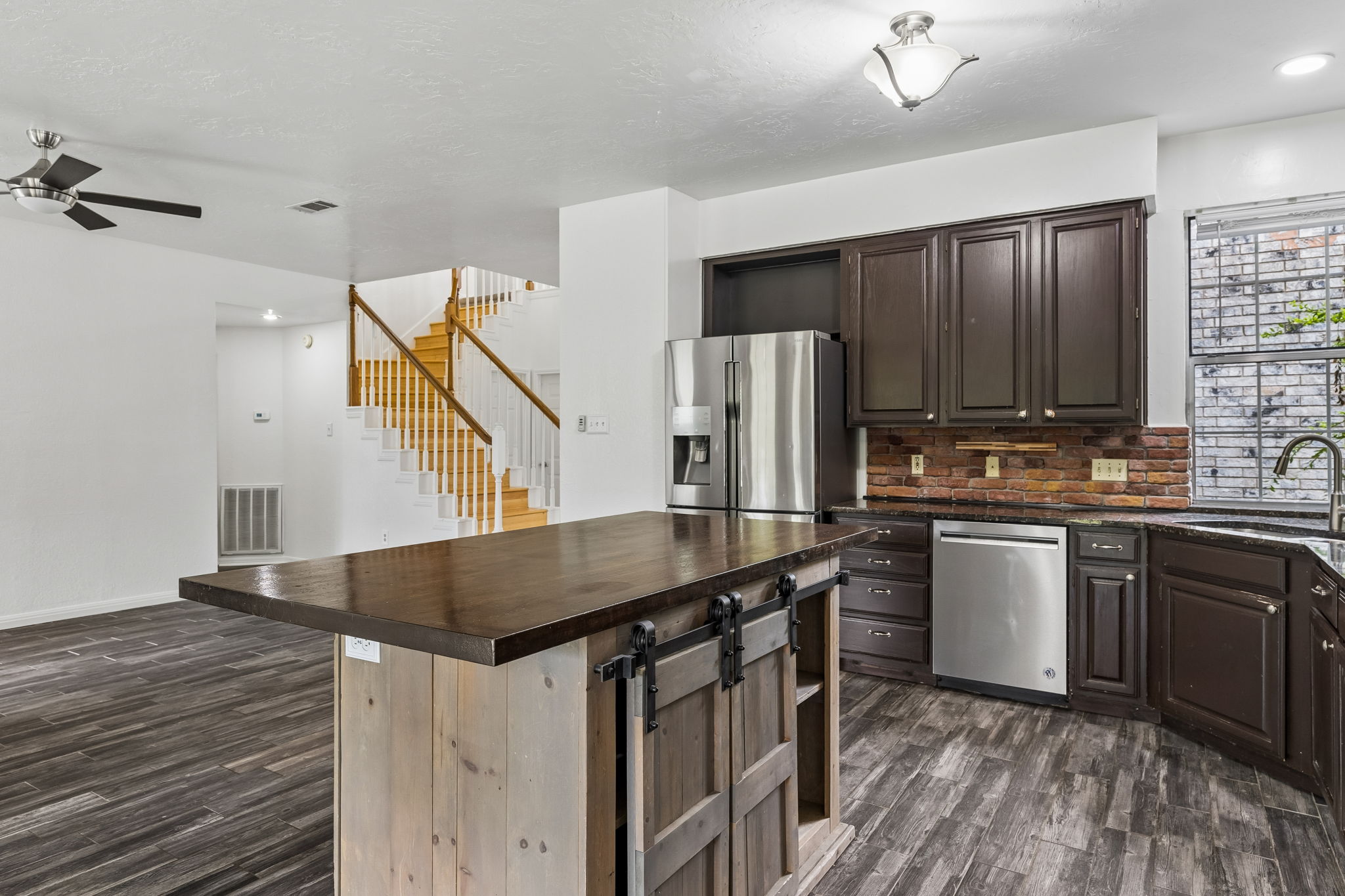 10400 O'Rourk Lane Austin, TX 78739 - Photo 8 of 33 a kitchen with stainless steel appliances kitchen island a refrigerator sink and microwave