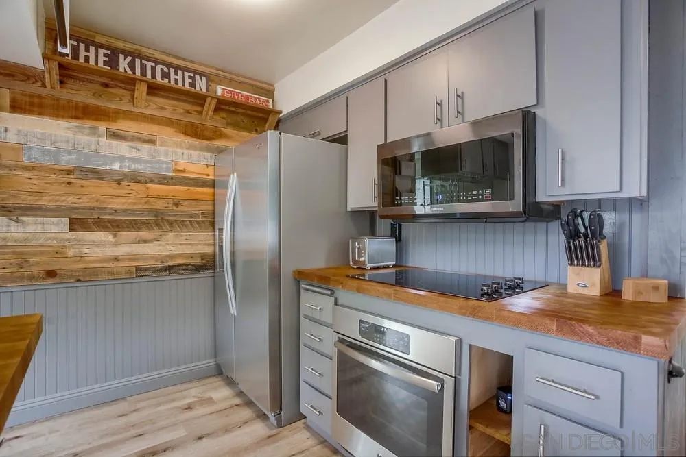 640 East Solana Circle Solana Beach, CA 92075 - Photo 3 of 15 a kitchen with stainless steel appliances granite countertop a refrigerator and a sink