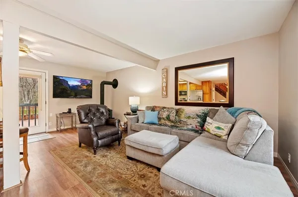 a living room with fireplace furniture and a flat screen tv