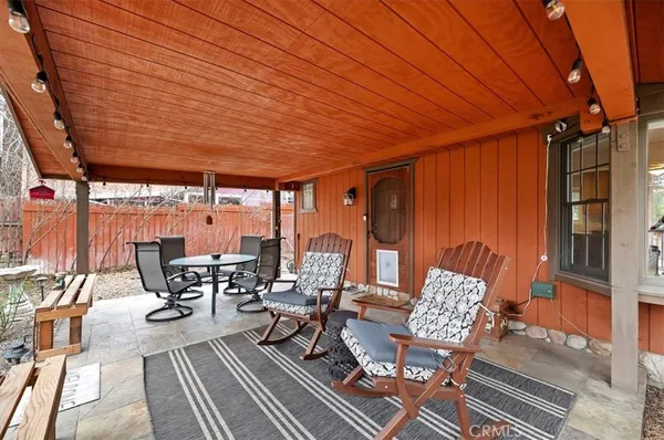 a view of a patio with table and chairs and potted plants