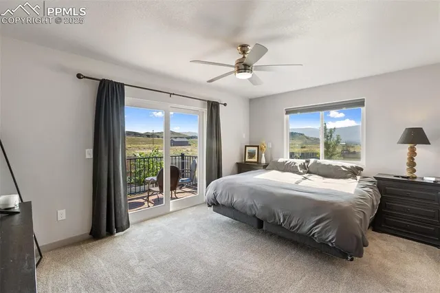 a bedroom with a large bed and a large window