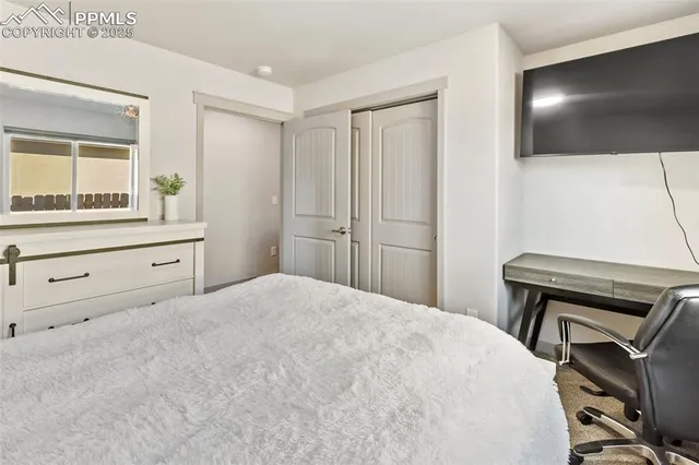 a bedroom with a bed and a flat screen tv