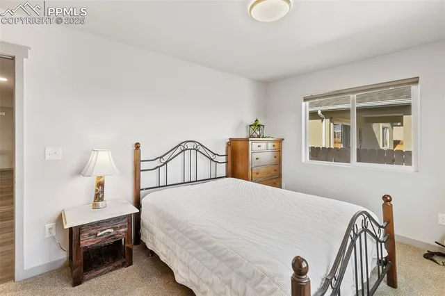 a bedroom with a bed and dresser with mirror