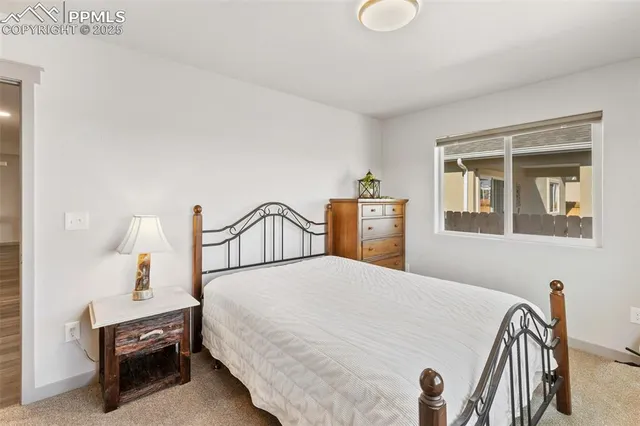 a bedroom with a bed and dresser with mirror