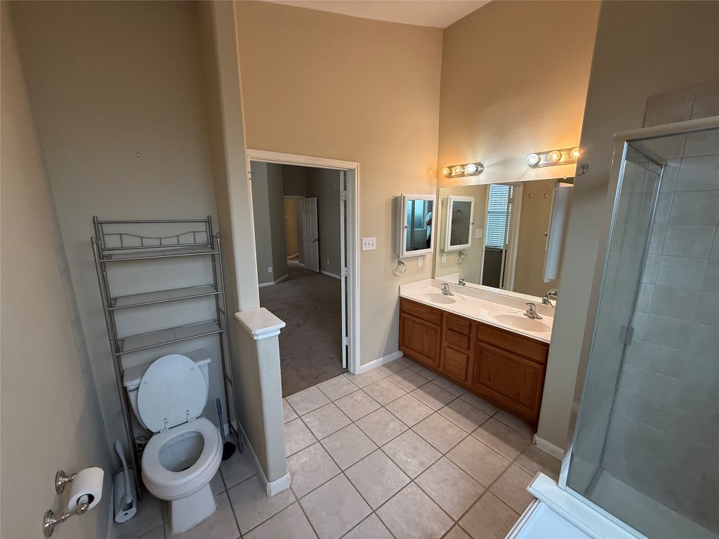 3011 Grovewick Lane Dickinson, TX 77539 - Photo 13 of 28 a bathroom with a sink mirror vanity and toilet