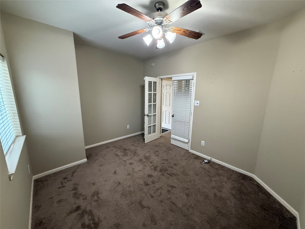 3011 Grovewick Lane Dickinson, TX 77539 - Photo 15 of 28 en empty room with windows and fan