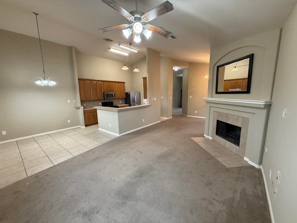 3011 Grovewick Lane Dickinson, TX 77539 - Photo 5 of 28 a view of a livingroom with a fireplace a microwave and a chandelier
