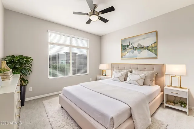 a bedroom with a bed and a painting on the wall