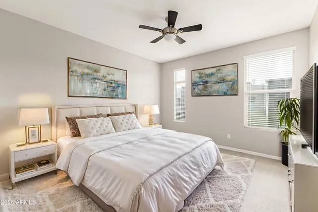 a bedroom with a bed and a painting on the wall