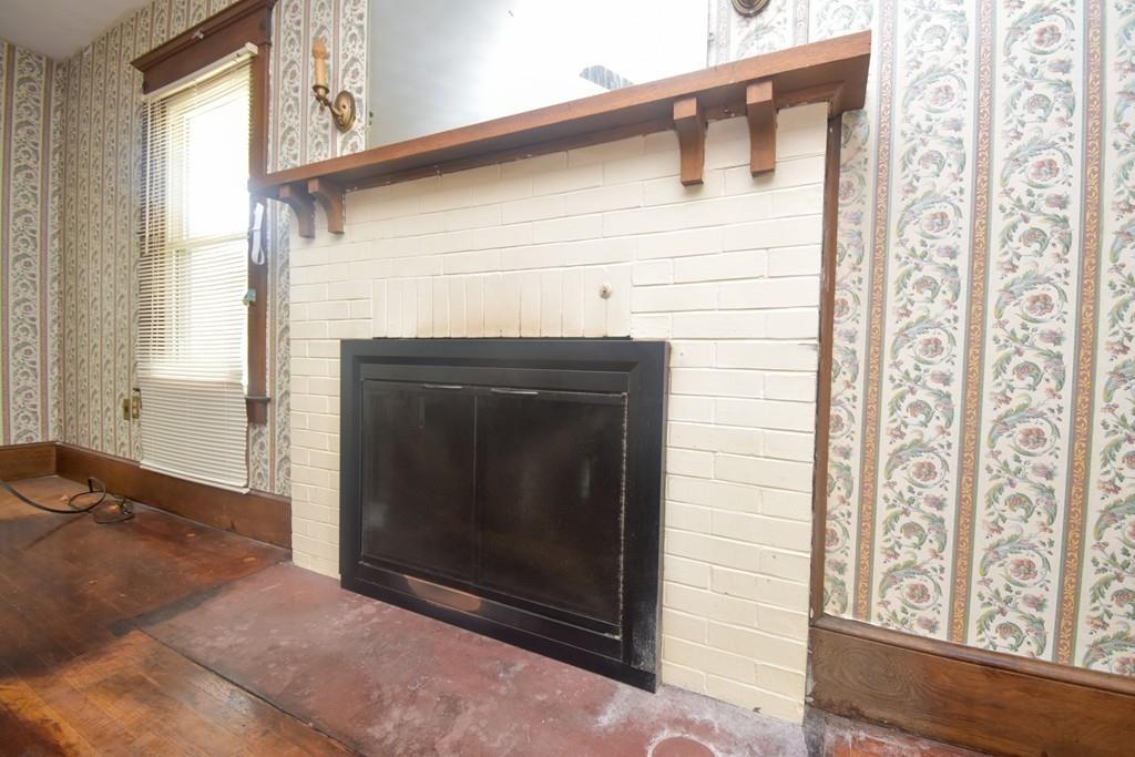 141 Oak Street Springfield, MA 01109 - Photo 4 of 40 a living room with a fireplace and a window