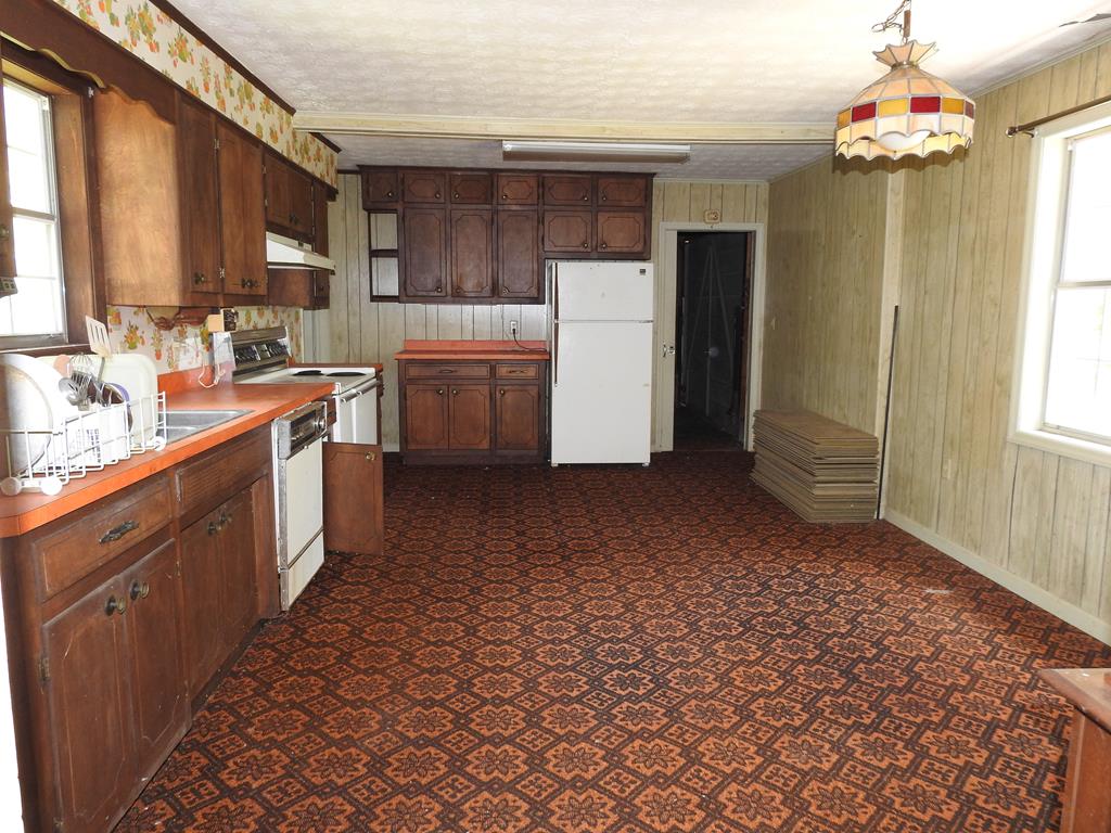 333 Lickskillet Road Epworth, GA 30541 - Photo 25 of 32 a kitchen with a refrigerator a sink and cabinets