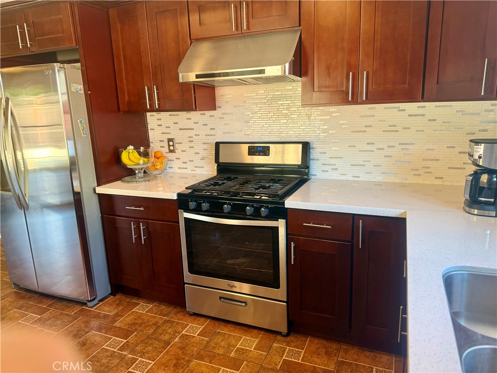 5982 Harrison Street Chino, CA 91710 - Photo 20 of 43 a kitchen with stainless steel appliances granite countertop a stove a sink and a refrigerator