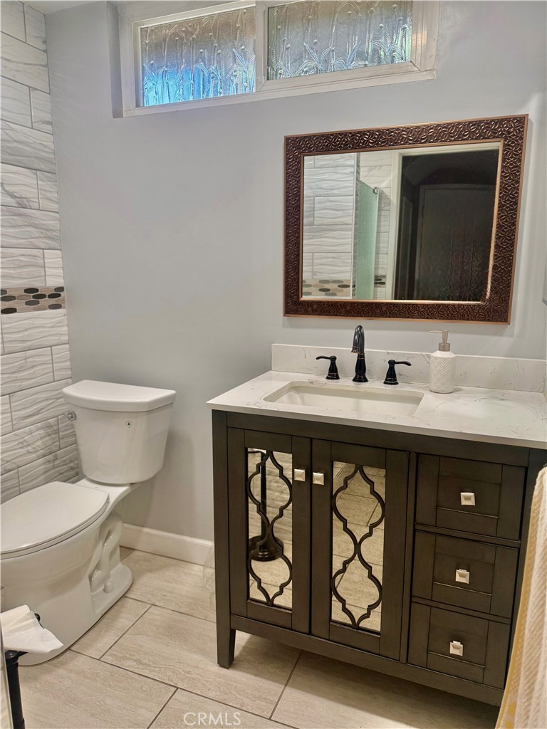 5982 Harrison Street Chino, CA 91710 - Photo 24 of 43 a bathroom with a toilet sink and mirror