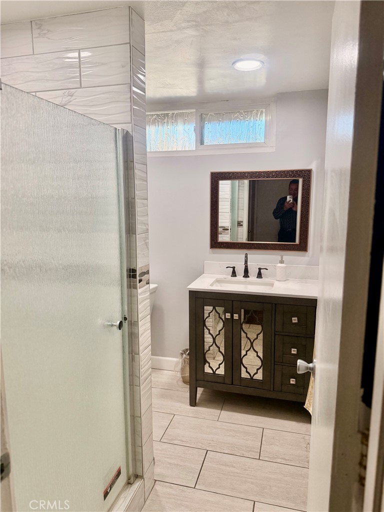 5982 Harrison Street Chino, CA 91710 - Photo 25 of 43 a bathroom with a sink a toilet and a mirror