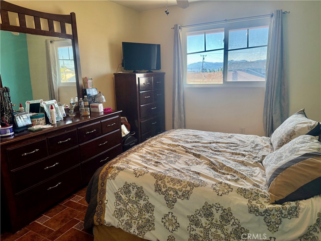 5982 Harrison Street Chino, CA 91710 - Photo 27 of 43 a bedroom with a bed and a flat screen tv