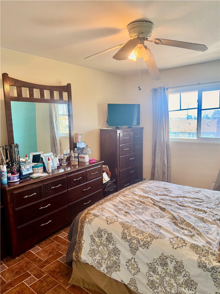 5982 Harrison Street Chino, CA 91710 - Photo 28 of 43 a bedroom with a bed and a chandelier
