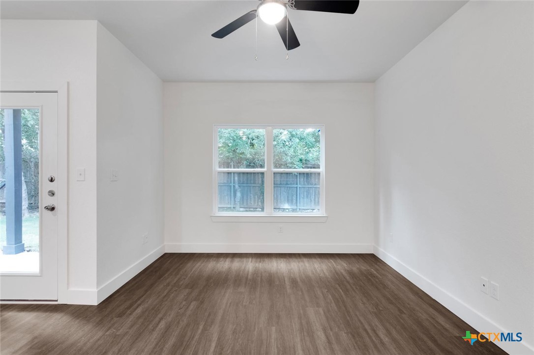 1924 Royal Loop Belton, TX 76513 - Photo 5 of 15 an empty room with wooden floor chandelier fan and windows