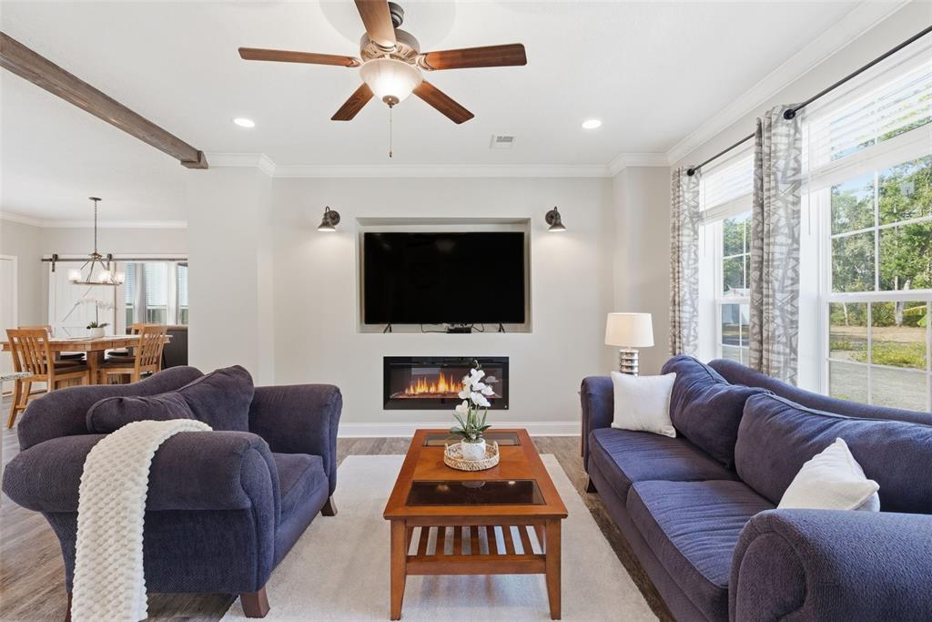 6170 La Pine Road Brooksville, FL 34602 - Photo 11 of 63 a living room with furniture a flat screen tv and a large window