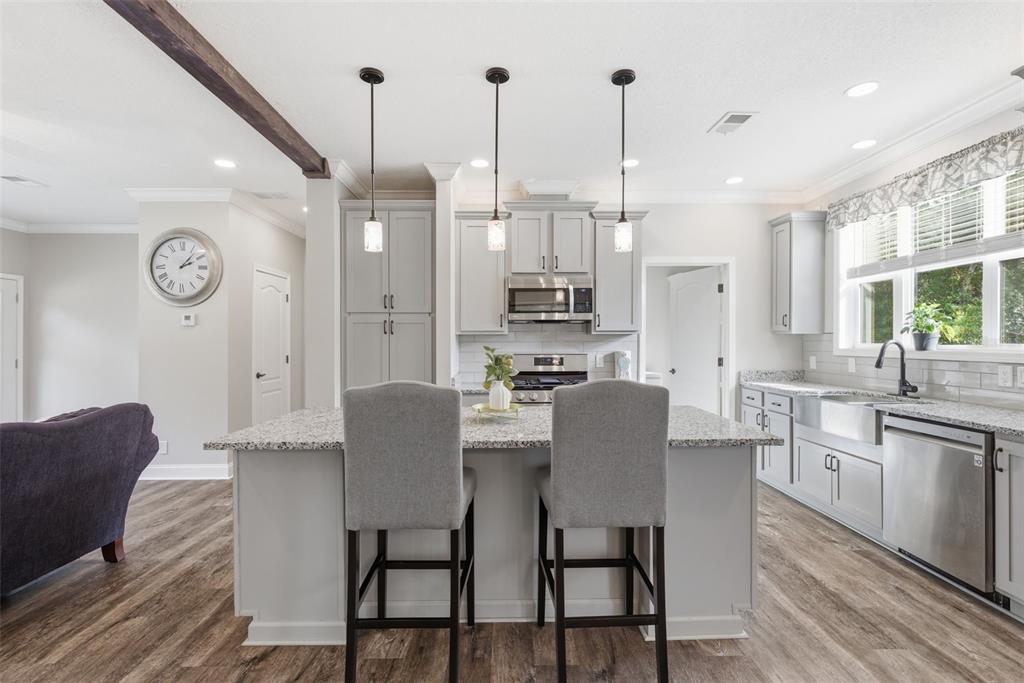 6170 La Pine Road Brooksville, FL 34602 - Photo 12 of 63 a dining room with furniture a chandelier and wooden floor