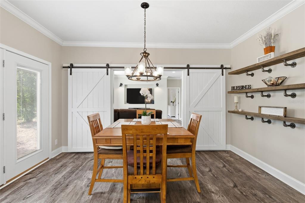 6170 La Pine Road Brooksville, FL 34602 - Photo 18 of 63 a view of a dining room with furniture window and wooden floor