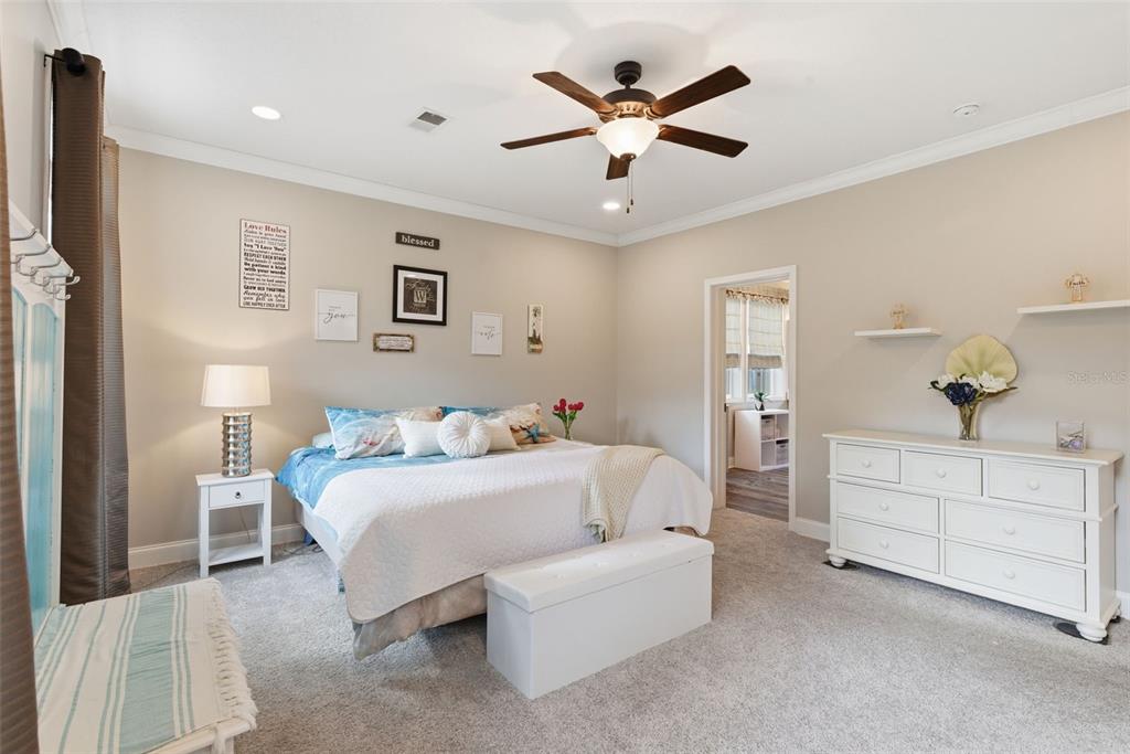 6170 La Pine Road Brooksville, FL 34602 - Photo 22 of 63 a spacious bedroom with a bed and a chandelier