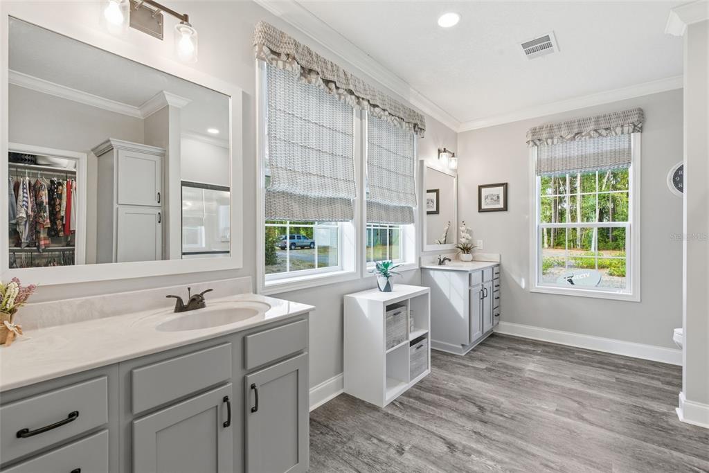 6170 La Pine Road Brooksville, FL 34602 - Photo 27 of 63 a view of bathroom with windows and dual sinks