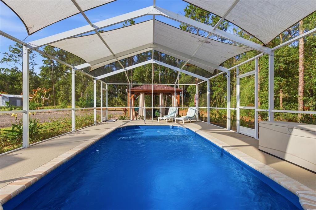 6170 La Pine Road Brooksville, FL 34602 - Photo 42 of 63 a view of a house with a large window and wooden floor