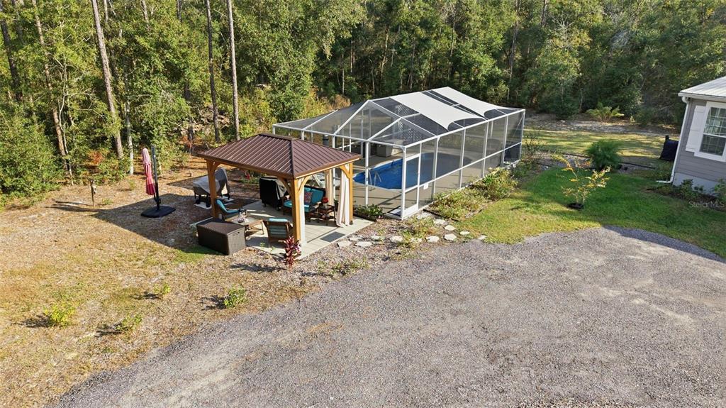 6170 La Pine Road Brooksville, FL 34602 - Photo 47 of 63 a view of a house with backyard and trees