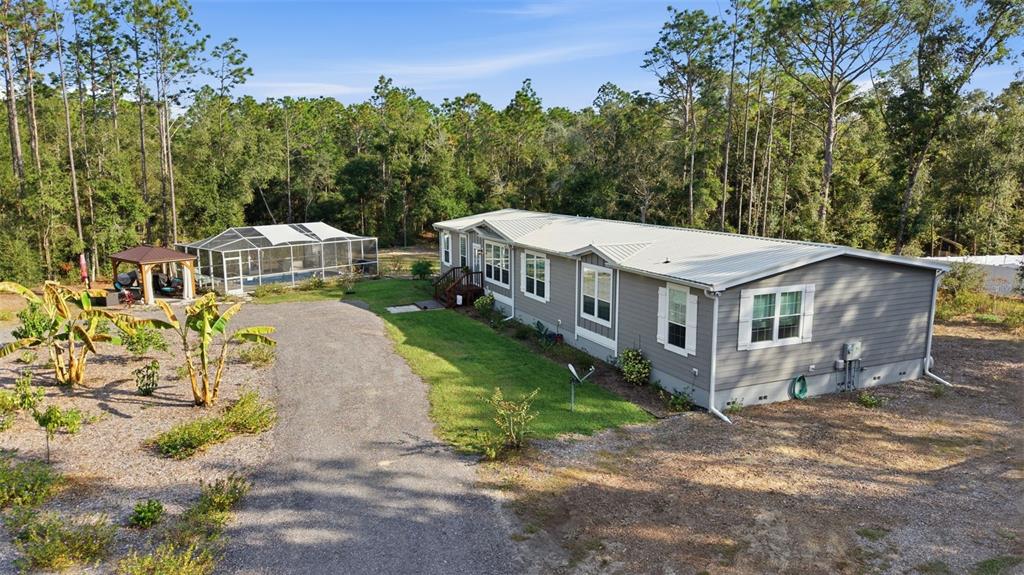 6170 La Pine Road Brooksville, FL 34602 - Photo 52 of 63 a view of a house with backyard and sitting area