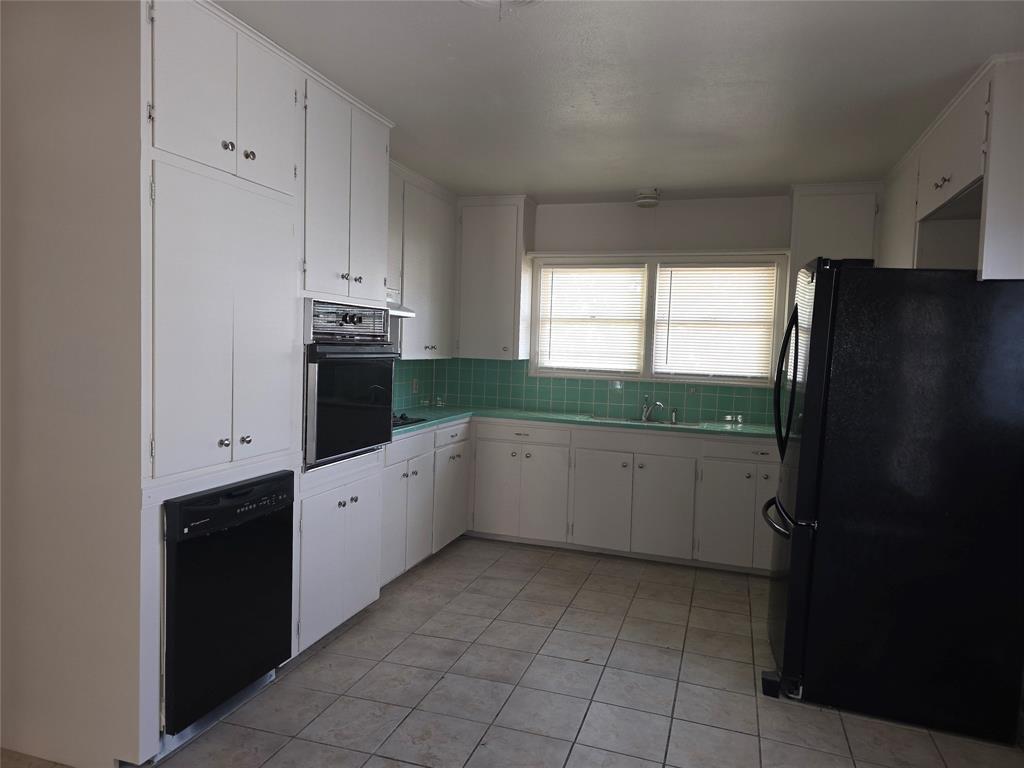 2717 Bilglade Road Fort Worth, TX 76133 - Photo 5 of 13 a kitchen with a refrigerator and window