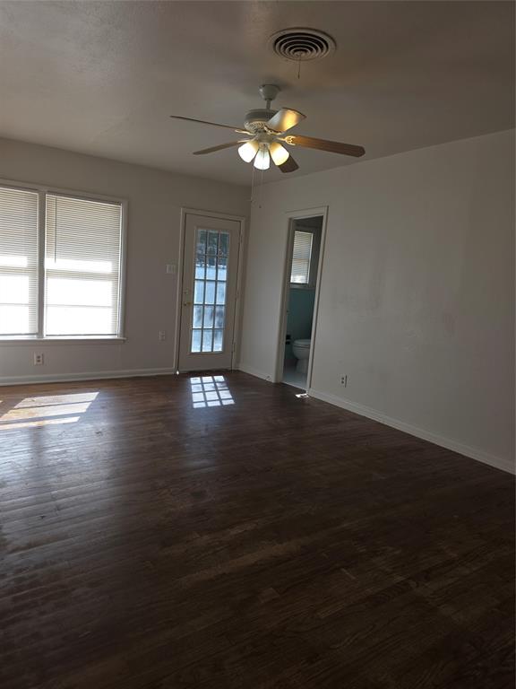 2717 Bilglade Road Fort Worth, TX 76133 - Photo 8 of 13 a view of an empty room with wooden floor and a window