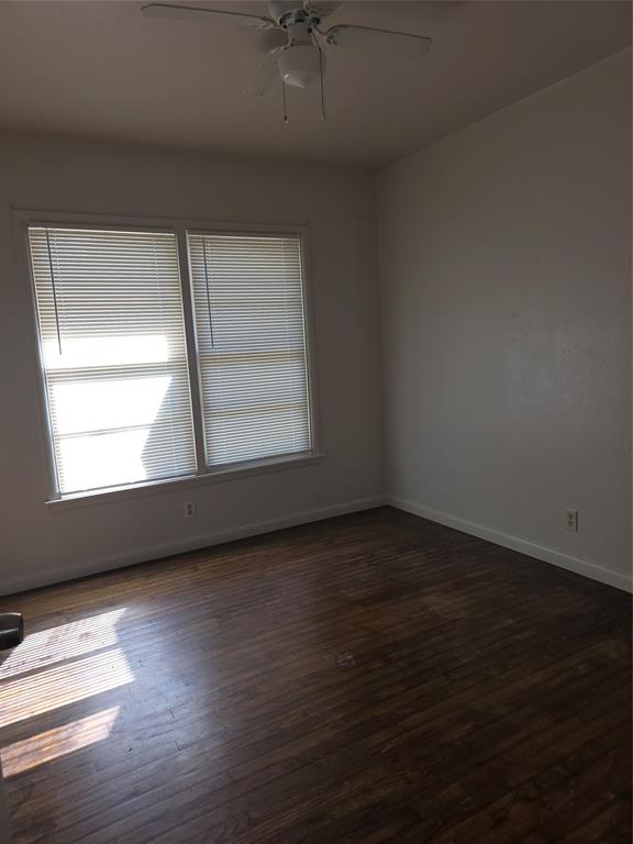 2717 Bilglade Road Fort Worth, TX 76133 - Photo 9 of 13 an empty room with wooden floor and windows