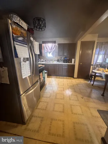 a view of a refrigerator in kitchen and dining room