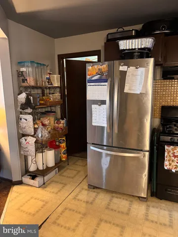 a kitchen with refrigerator and cabinets