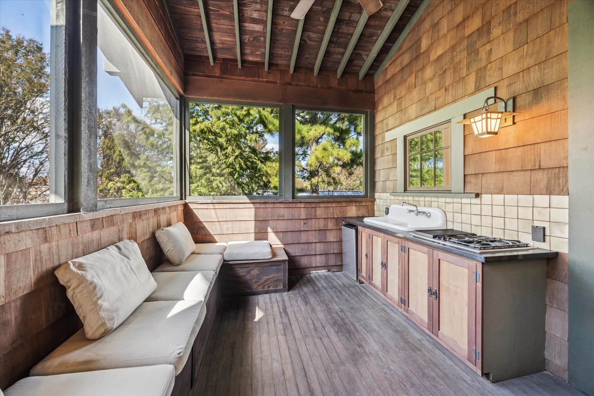 512 Archer Street Houston, TX 77009 - Photo 25 of 40 Cedar-clad screened porch with vaulted ceiling, outdoor kitchen including gas cooktop, sink, and mini fridge, conveniently accessible from the primary suite or second floor.