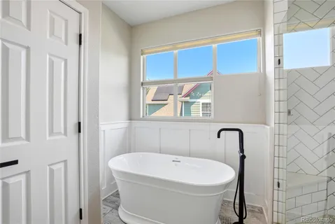 a white bath tub sitting next to a white sink
